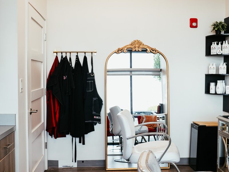 Styling stations and a gold arched mirror inside Style Me Up Hair Salon's Overland Park studio